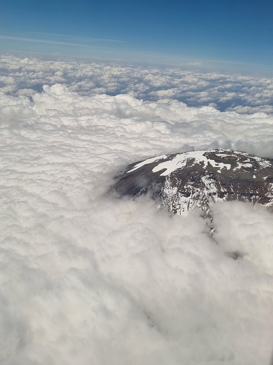 Mt. Kilimanjaro peaking through the clouds — Mount Kilimanjaro, Tanzania