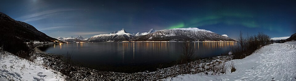 Aurora borealis above Storfjorden and the Lyngen Alps in moonlight, 2012 March — Geirangerfjord, Norway