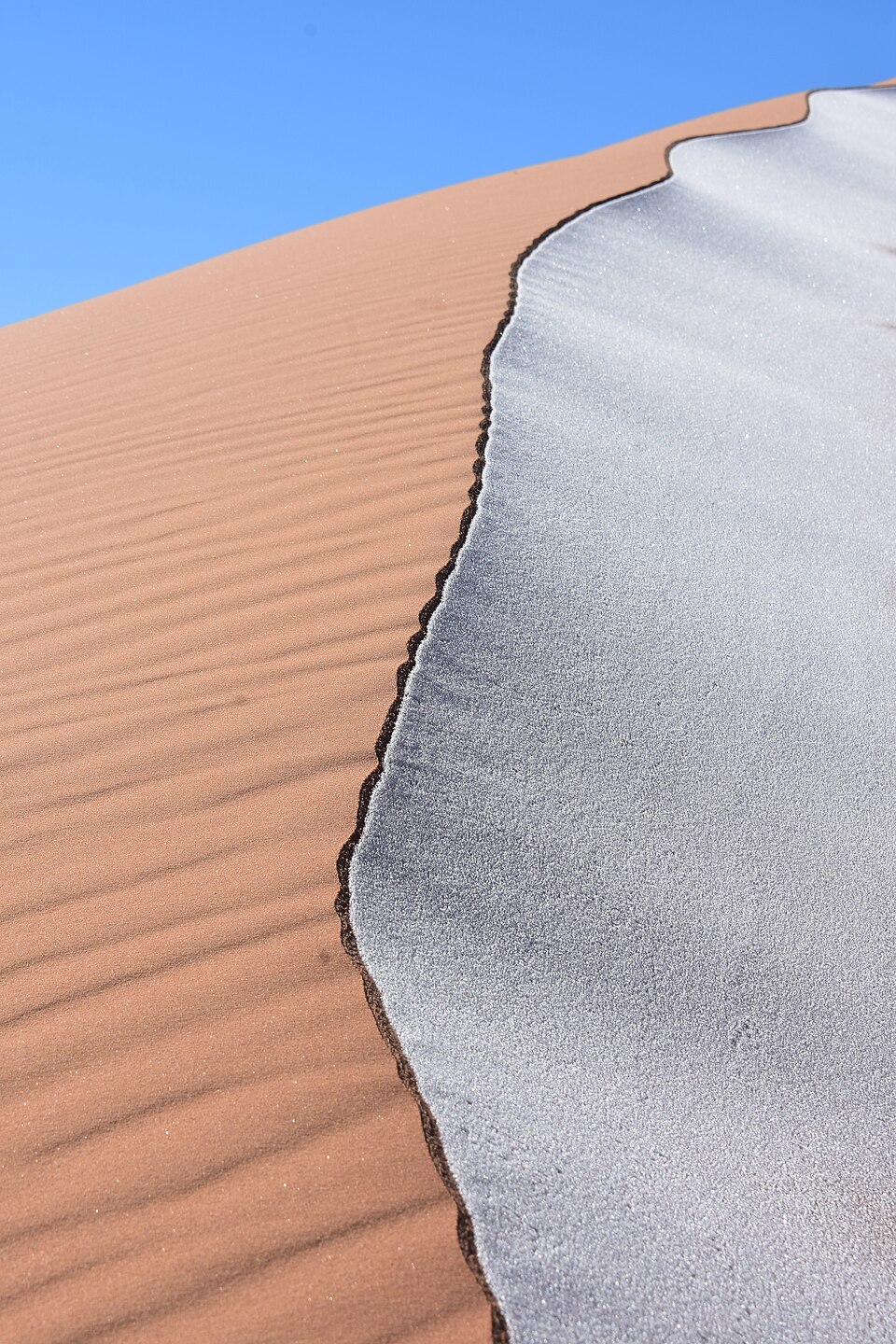 Ice streaks the sand dunes of the Sahara Desert in northwestern Algeria — Erg Chebbi, Morocco