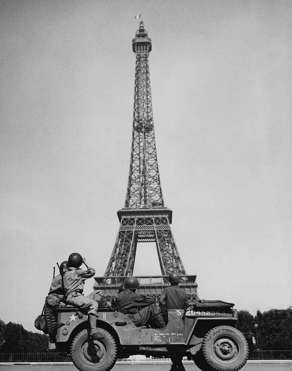 American soldiers watch as the Tricolor flies from the Eiffel Tower again — Paris, France